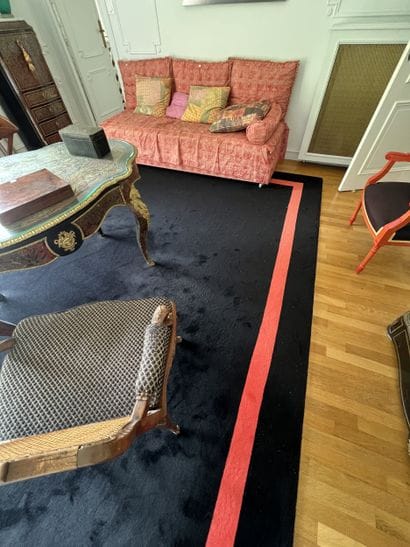Black carpet with coral braid border. 
Contemporary...