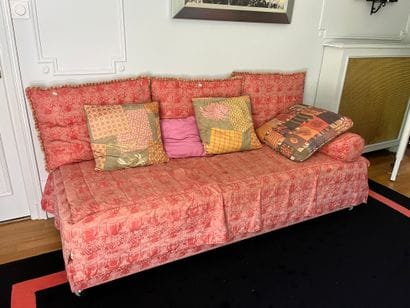 Sofa with bed covered in red fabric