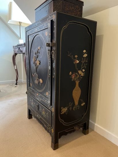 Small low piece of furniture in black lacquered...