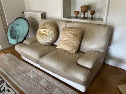 Two two-seater sofas in beige leather, with...