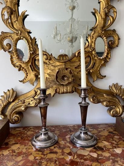 Pair of silver-plated candlesticks. The shaft...