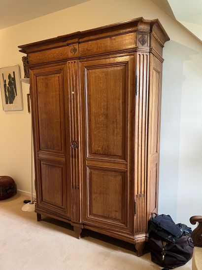 Molded and carved oak armoire. Opens to two...