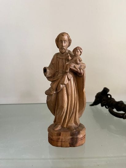 Carved limewood man carrying a child 19th...