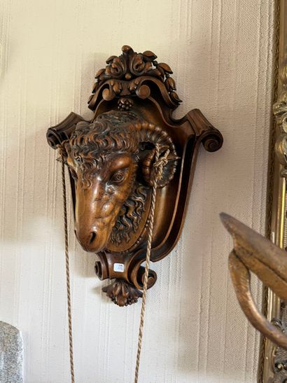Walnut wall lamp featuring a ram's head on...