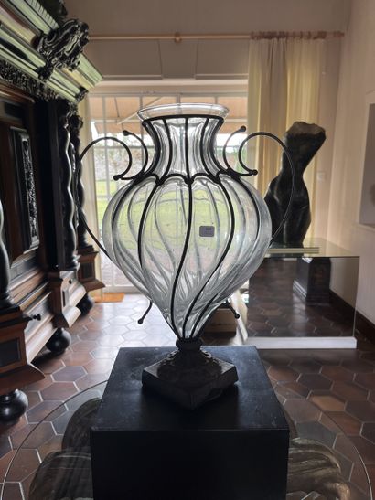 Blown glass vase, molded in a metal frame,...