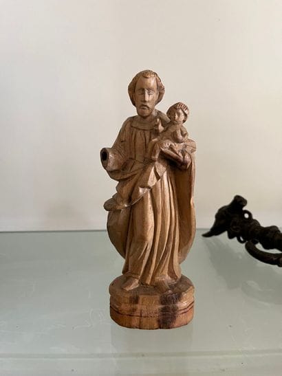 Carved limewood man carrying a child 19th...