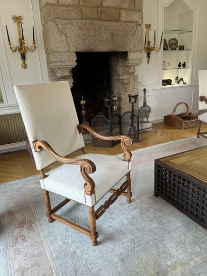 Suite of three molded and carved walnut armchairs,...