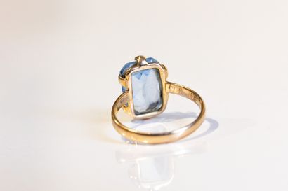Bague en or jaune ornée d'une pierre bleue...