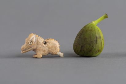 Pendant amulet depicting a stylized wild...