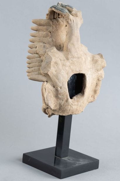 Head of a figure. The mouth is open, revealing...