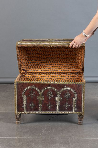 Leather-covered chest with a studded design...