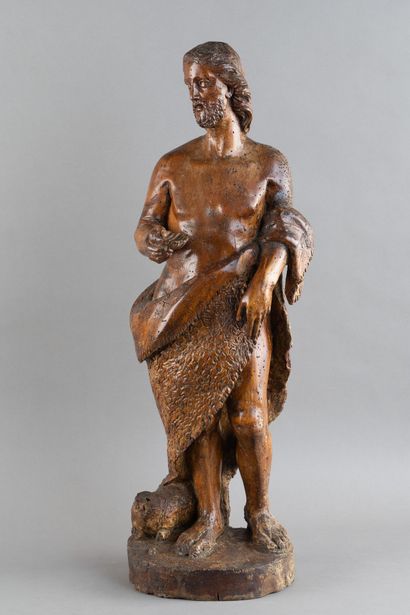 A carved wooden statue of Saint John the...