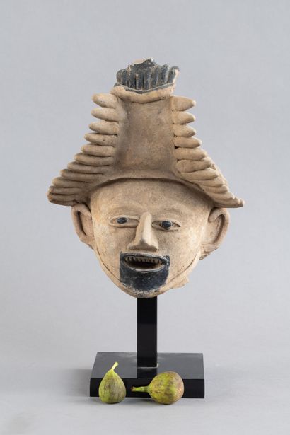 Head of a figure. The mouth is open, revealing...