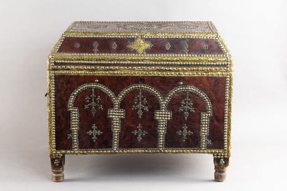 Leather-covered chest with a studded design...