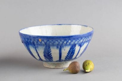 A hollow ceramic bowl decorated with large...