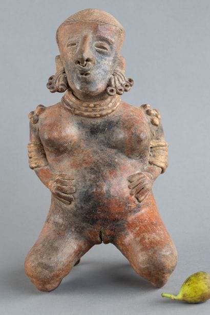 Statuette of a woman in labor. She is depicted...