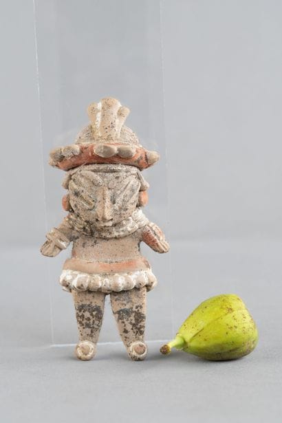 Statuette of a standing woman. She is adorned...