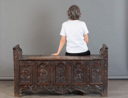 Oak storage bench with a five-panel carved...