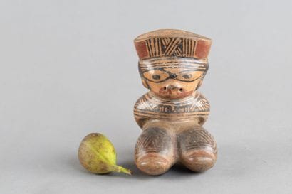 Female statuette depicted in a crouching...