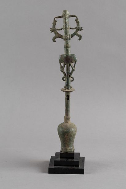 Flag finial depicting a hero subduing two...