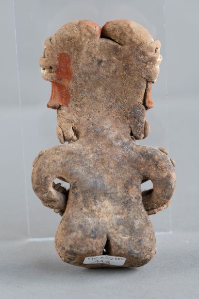 Female statuette depicted seated and pregnant,...