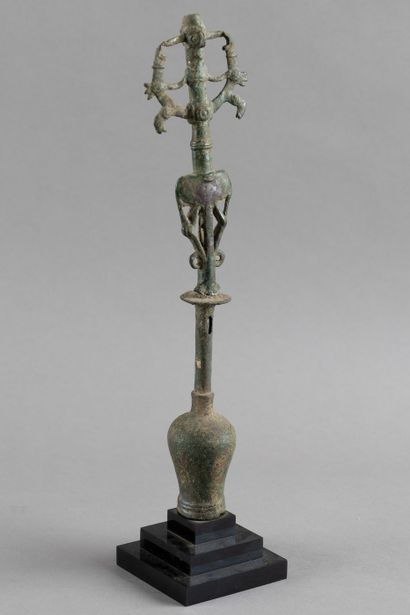 Flag finial depicting a hero subduing two...