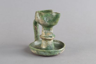 Green ceramic oil lamp with a tall stem and...