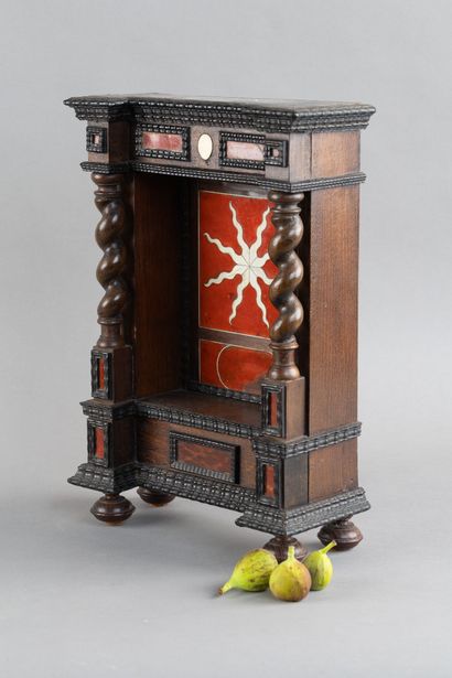 Display case with a niche framed by twisted...