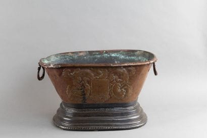 Copper basin with a repoussé coat of arms...