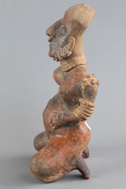 Statuette of a woman in labor. She is depicted...