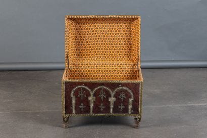 Leather-covered chest with a studded design...