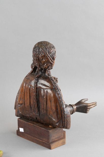 Carved wooden bust of a saintly woman. She...