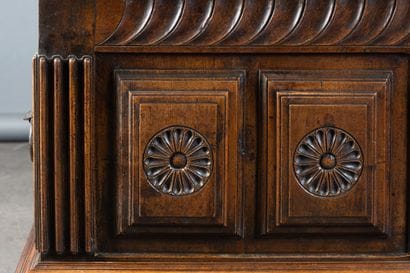 Walnut chest with a front panel featuring...