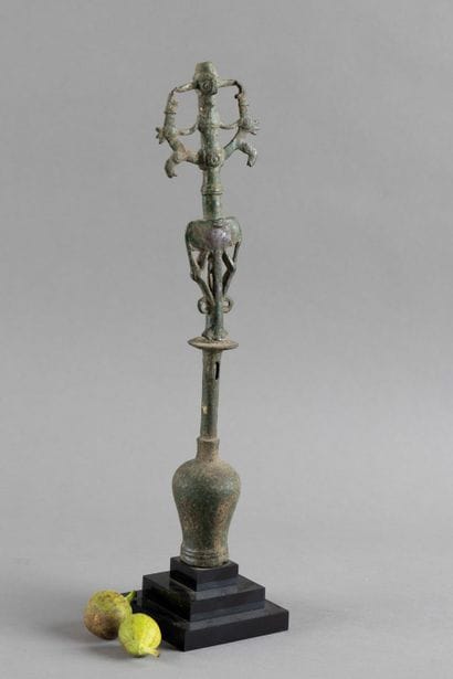 Flag finial depicting a hero subduing two...