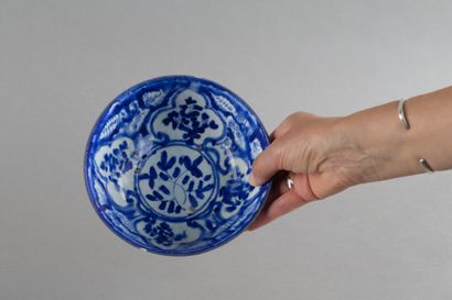 A hollow ceramic cup decorated with four...