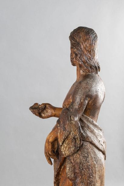 A carved wooden statue of Saint John the...