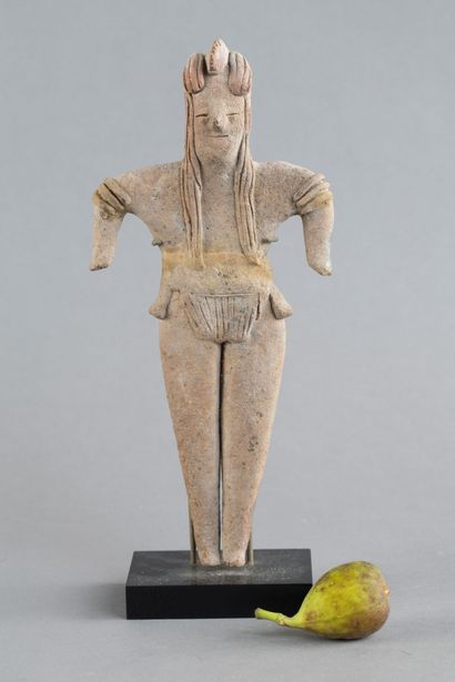 Statuette depicted standing with both short...