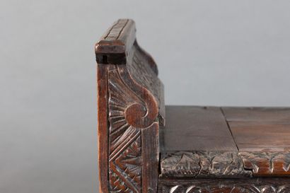 Oak storage bench with a five-panel carved...