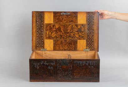Cedar chest with a top-opening lid, featuring...