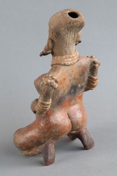 Statuette of a woman in labor. She is depicted...
