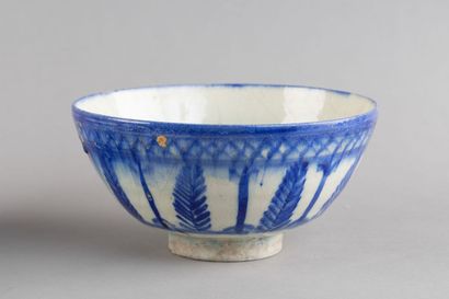 A hollow ceramic bowl decorated with large...