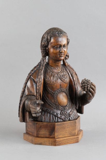 Carved wooden bust of a saintly woman. She...