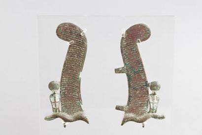 Pair of feathers flanked by cobras. Bronze....