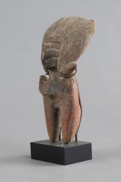 Female statuette. The hairstyle is notable,...