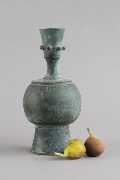 Bronze bottle with a rounded body, resting...