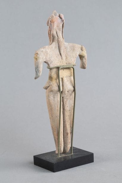 Statuette depicted standing with both short...