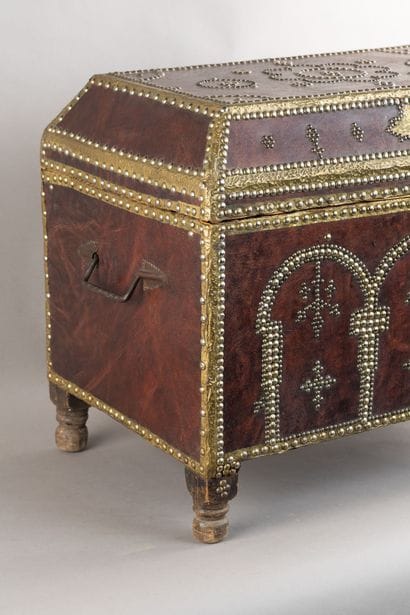 Leather-covered chest with a studded design...
