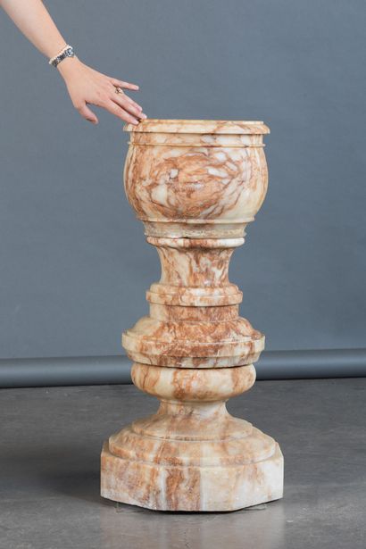 Bowl resting on a turned, molded base made...