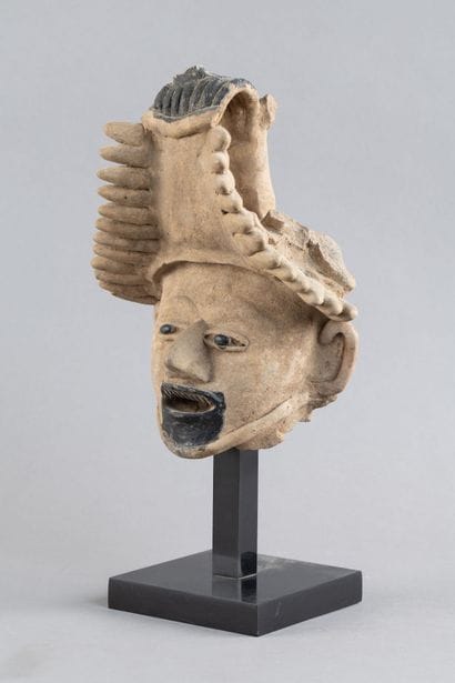 Head of a figure. The mouth is open, revealing...