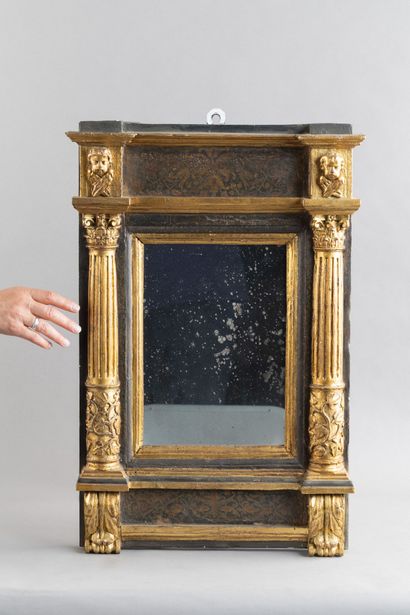Molded and carved wooden mirror; the mirror...